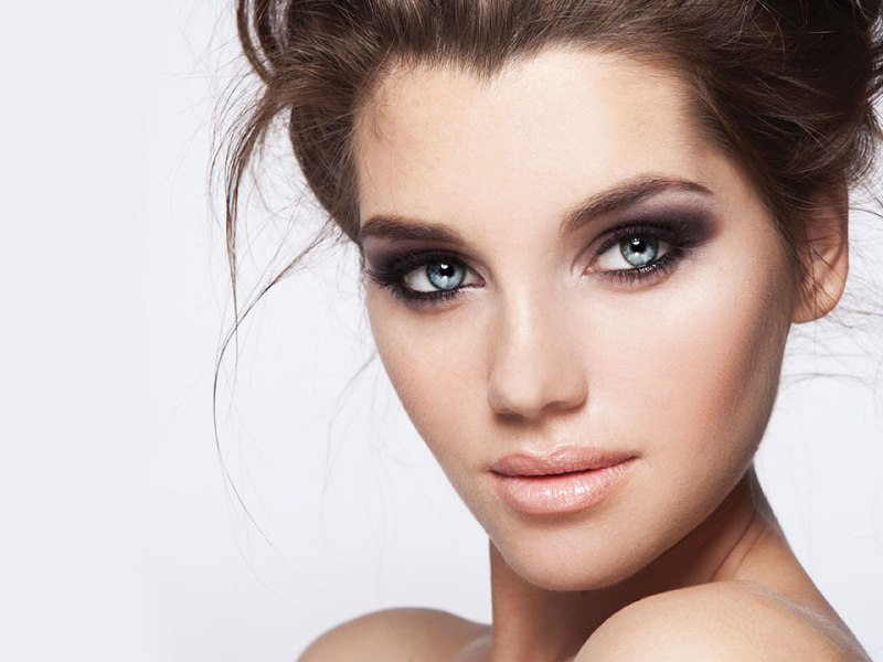 Young woman with striking makeup, featuring bold eye makeup and soft lip color, showcasing beauty and self-care at Muses Spa & Beauty Boutique.